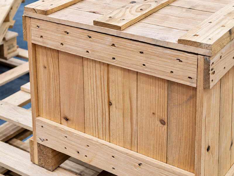 Wooden shipping crate sitting on a pallet.